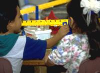 Grade school children learning equals unequal on math balance