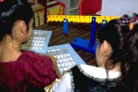 Elementary school children solving algebraic equations on math balance