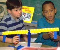 Elementary school children solving problems on math balance
