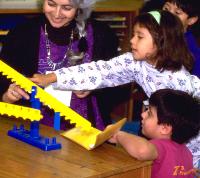 Child demonstrating equals on math balance