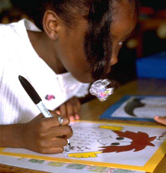 African American girl working a monster addition problem with 7-digit numbers